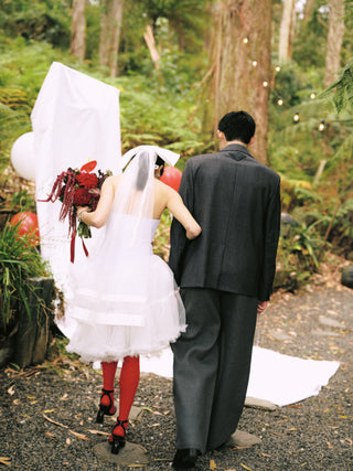Wedding couple walking away in a forest setting